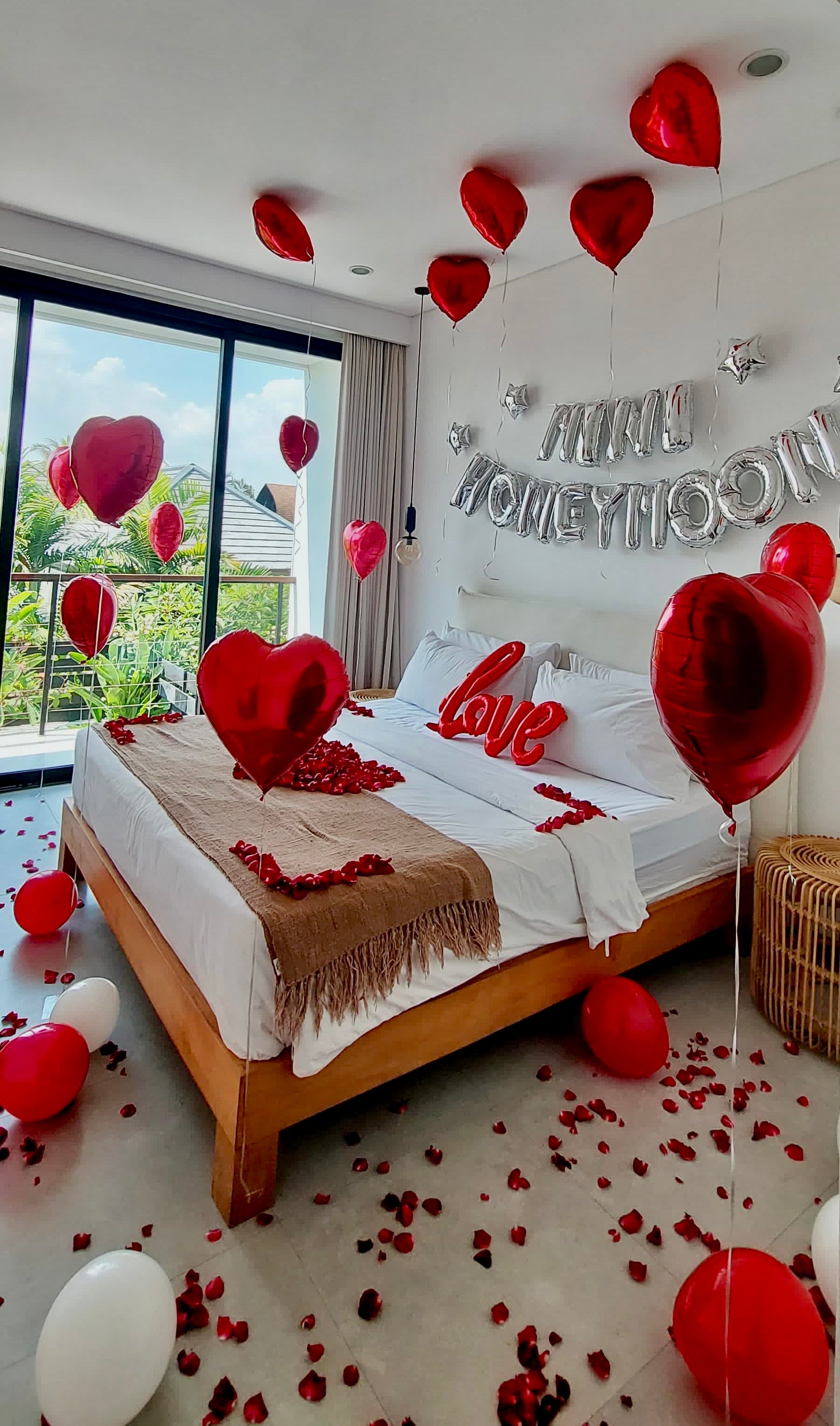 happy honeymoon decorations and banner setup inside Bali villa bedroom