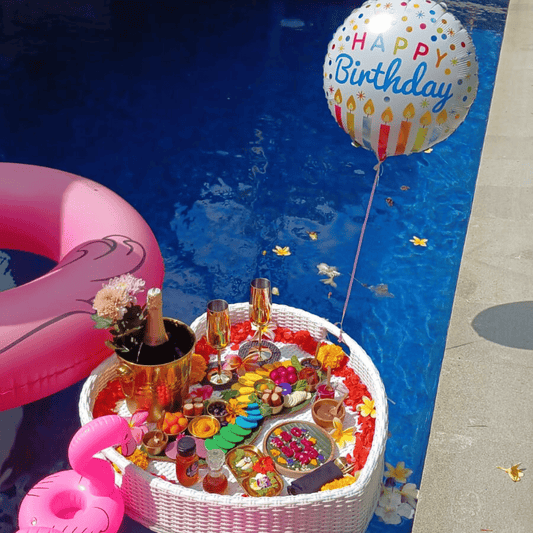 birthday floating breakfast tray with balloon and fruit art in Bali villa pool